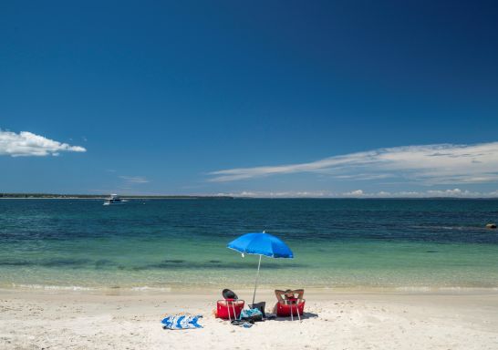 Couple enjoying a day ay Huskisson Beach, Jervis Bay