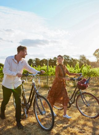 Couple enjoying a bike ride around the Clonakilla Wines vineyard in Murrumbateman, Yass Area