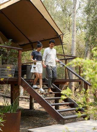 Couple enjoying a romantic glamping getaway at Paperbark Camp, Woollamia, Jervis Bay and Shoalhaven