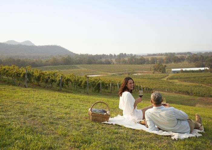 Couple enjoying a glass of wine at Audrey Wilkinson Wineries, Pokolbin