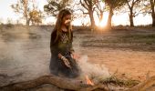 Young girl from the Barkindji nation preparing leaves for a smoking ceremony, Wilcannia