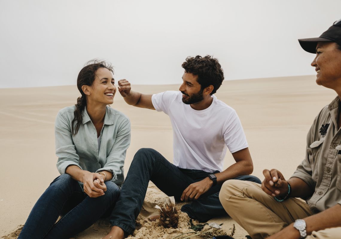 Couple enjoying a Sand Dune Adventure tour with an Aboriginal Guide in Port Stephens, Destination NSW