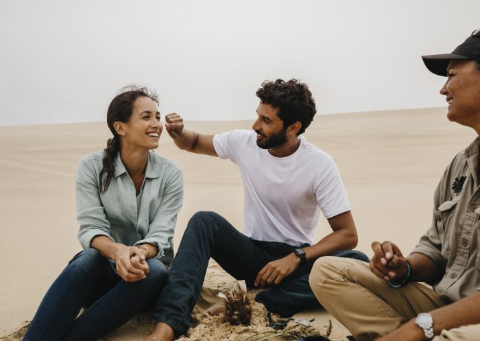 Couple enjoying a Sand Dune Adventure tour with an Aboriginal Guide in Port Stephens, Destination NSW