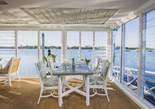 The interior of the Whalebone Wharf seafood restaurant with views across Hastings River, Port Macquarie, North Coast
