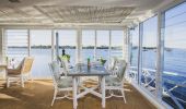 The interior of the Whalebone Wharf seafood restaurant with views across Hastings River, Port Macquarie, North Coast