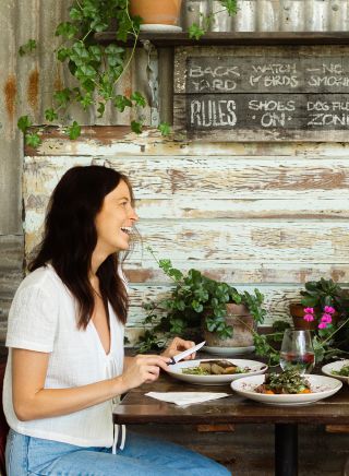 Couple enjoying food and drink at Yum Yum Angourie Cafe and General Store, Yamba