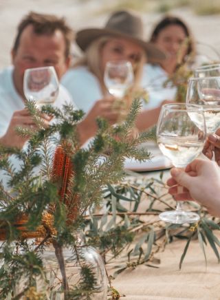 Group enjoying a dining experience on the White Sands Coast, Jervis Bay
