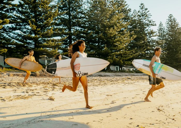 NRMA Murramarang Beachfront Holiday Resort, South Durras Friends running towards the surf at NRMA Murramarang Beachfront Holiday Resort, South Durras
