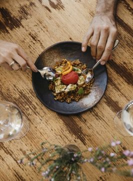 Couple enjoying food and drink at Zecca Restaurant, Griffith
